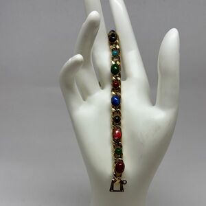 Gold tone bracelet with glass cabochons